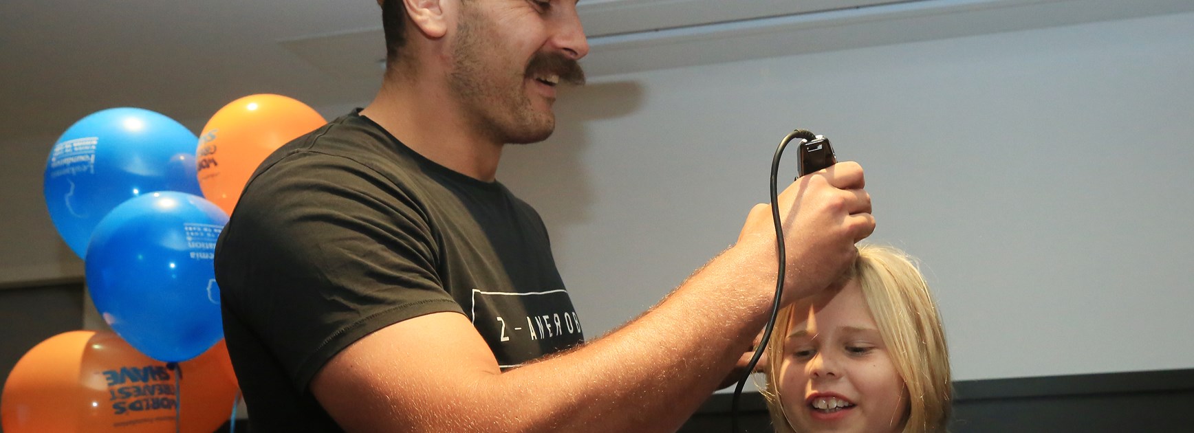 CLOSE SHAVE: Reagan-Campbell Gillard took hold of the clippers as Sammy Bishop, 10, said goodbye to her golden locks to raise funds for the Leukaemia Foundation