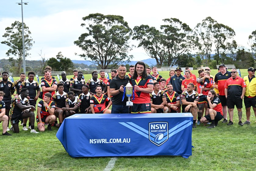 Macedonia captain James Mirceski (R) receives the trophy. Photos: Kristie Laird