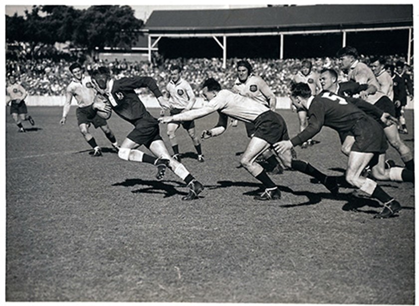 Queensland’s Bill Callinan gets past NSW winger Ron Roberts in an interstate clash in 1949, which NSW won 40-12.