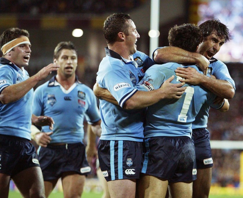 Captain Andrew Johns leads celebration after one of fullback Anthony Minichiello's two tries in Origin I, 2003.